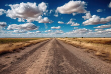 A Path On The Side Of The Dirt Field Is Under The Blue Sky And White Clouds. High -quality Photo