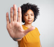© Nicholas Felix/peopleimages.com - Portrait, palm and warning with a woman in studio on a gray background for control or to stop abuse. Hand, protest and body language with an attractive young female person saying no in disagreement