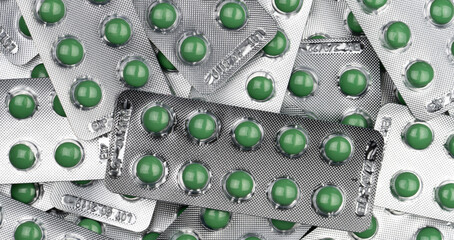 Wall Mural - Full frame green round pills in blister pack. Prescription medicine. Top view of green tablet pills. Pharmaceutical manufacturing industry. Health care and medical concepts. Vitamin and supplement.