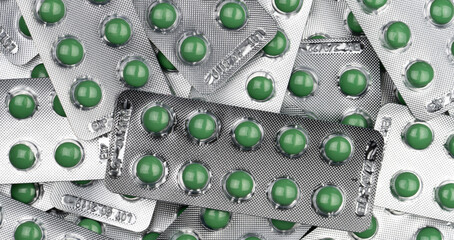 Sticker - Full frame green round pills in blister pack. Prescription medicine. Top view of green tablet pills. Pharmaceutical manufacturing industry. Health care and medical concepts. Vitamin and supplement.