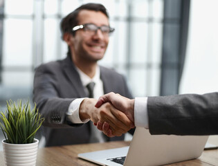 handshake of business partners at a meeting in the office