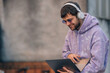 young man with laptop and headphones