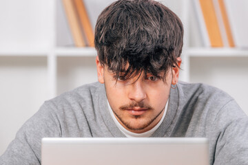 Sticker - student looking at computer or laptop