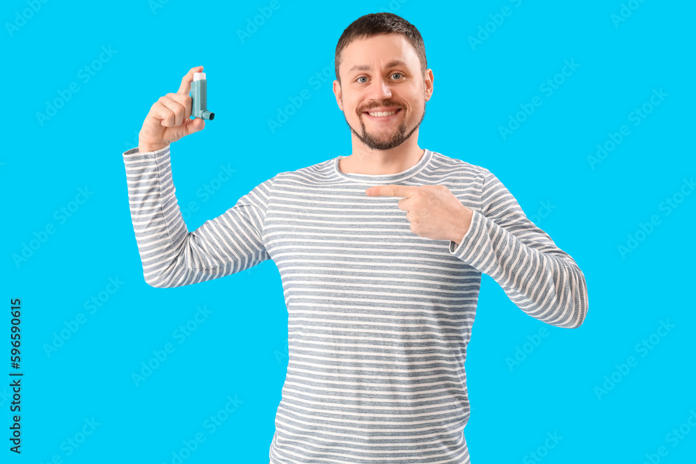 Man with inhaler on blue background