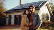 © piai - A happy couple stands smiling in the driveway of a large house with solar panels installed. Generative AI
