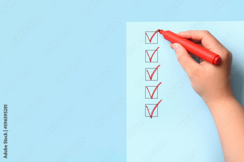 Woman marking on checklist box with red marker