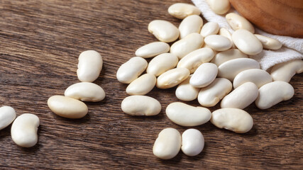 Wall Mural - Pile of white beans closeup on wooden table