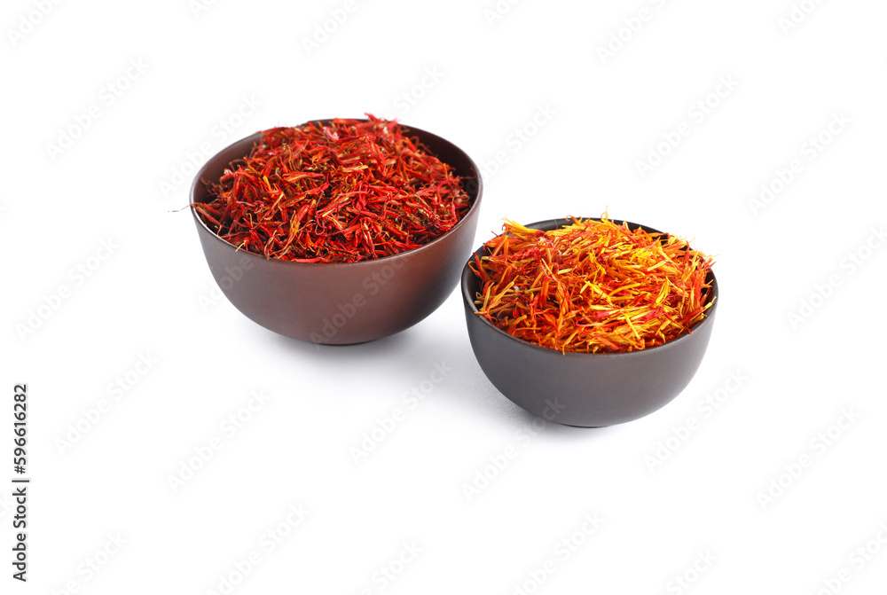 Bowls with pile of saffron on white background