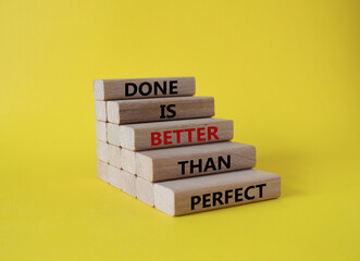 Wall Mural - Done is better than Perfect symbol. Wooden blocks with words Done is better than Perfect. Beautiful yellow background. Business and Done is better than Perfect concept. Copy space.