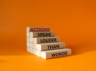 Wall Mural - Actions speak louder than Words symbol. Wooden blocks with words Actions speak louder than Words. Beautiful orange background. Business and Actions concept. Copy space.