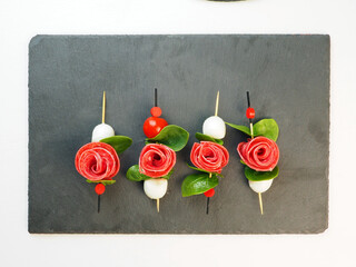 Wall Mural - Appetizer - canape in the form of a rose flower with leaves