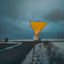 Yellow Road Sign At Crossroads In Winter