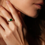 Fototapeta  - Beautiful woman closeup profile portrait with natural manicure wearing a ring with green gem