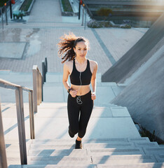 Poster - Her fitness levels are on the rise. Full length shot of an attractive young female athlete exercising outside in the city.