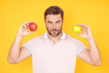 People with apple. Portrait of man eating apple isolated over studio background. Healthy apple fruit for natural vitamin, dieting and healthy lifestyle. Studio portrait of strong man eat green apple.