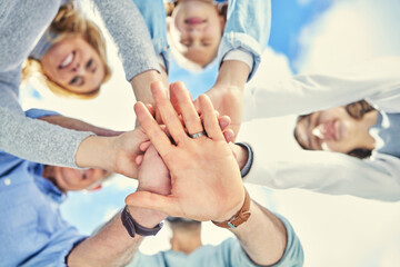 Wall Mural - .. Shot of a family stacking their hands in the garden outside.