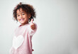 © Courtney/peopleimages.com - Nothing but good vibes. Shot of an adorable little girl standing alone and showing a thumbs up against a grey background.