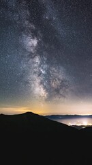 Wall Mural - vertical video of milky way galaxy time lapse night stars sky over countryside
