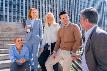 Talking before going to work. Group of coworkers outdoors in a corporate office area