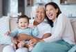 © Nina L/peopleimages.com - Couldnt be happier. Shot of a mature woman bonding with her granddaughter and daughter on the sofa at home.