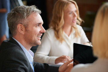 Wall Mural - Hes excited to share his ideas too. Shot of a mature businessman having a meeting with his colleagues in an office.