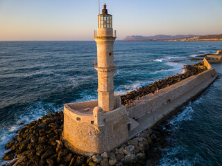 Poster - Aerial view of the old Venetian era lighthouse in the harbor of Chania at sunset (Crete, Greece)