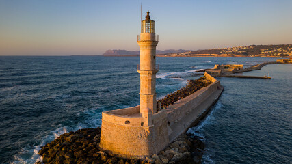 Wall Mural - Venetian lighthouse in the harbor of Chania (Crete, Greece) bathed in golden light from the setting sun