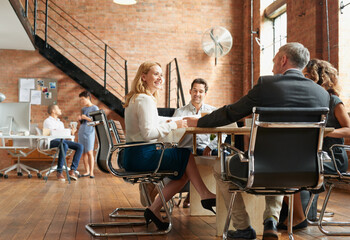 Wall Mural - Getting all the best ideas flowing. Shot of a group of businesspeople having a meeting in an office.