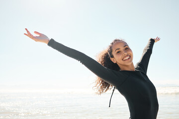 Canvas Print - Learn to read the ocean better. Shot of a young woman celebrating on the beach.