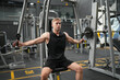 © FotoArtist - Man doing weight lifting exercises inside the gym