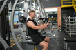 © FotoArtist - Man doing weight lifting exercises inside the gym
