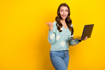 Wall Mural - Photo of young surprised it specialist girl wear cardigan freelance hold netbook point finger mockup website jobs isolated on yellow color background