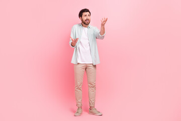 Full size photo of attractive young man hands irritated argument stressed wear trendy blue outfit isolated on pink color background