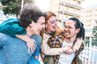© Nicolas Micolani - group of friends having fun outdoors making piggyback pose-Young multiracial people enjoying summer holiday and laughing together- Freedom Lifestyle concept with girls and guys