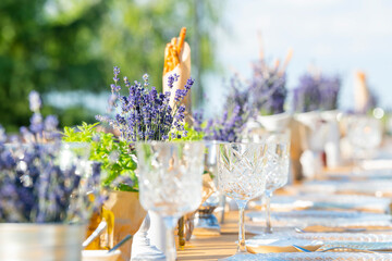 Poster - Beautiful outdoor celebration table green background with lavender decoration
