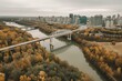 Drone view of autumnal North Saskatchewan river & downtown Edmonton from Rossdale with James MacDonald bridge. Generative AI