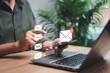 © NongAsimo - Business email marketing notification concept, Businessman use smartphones receive message alert in the mailbox and transfer data with laptop to mailing contacts phone Global Letters