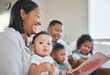 © Kirsten D/peopleimages.com - Theyre the best story tellers. Shot of a young family happily bonding together on the sofa at home.