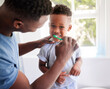 © Irshaad Majal/peopleimages.com - Dads showing me how to brush properly. Shot of a father brushing his sons teeth in the bathroom at home.