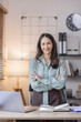 © David - Happy young business Asian woman posing isolated over grey office background.