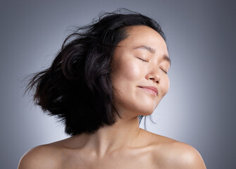 Poster - Let your hair free. Shot of a young woman standing against a grey background.