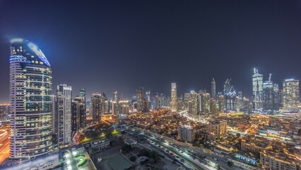 Canvas Print - Dubai's business bay towers aerial night timelapse. Rooftop view of some skyscrapers