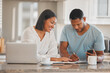 © Kirsten D/peopleimages.com - We definitely made some savings. Shot of a couple going over paperwork together at home.