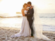 © Nina L/peopleimages.com - I pledge to honour you, love you and cherish you. Shot of a young couple on the beach on their wedding day.