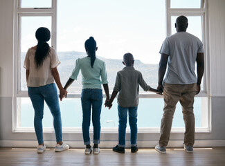 Wall Mural - In family life, love is the oil that eases friction. Shot of a beautiful young family bonding while spending time together at home.