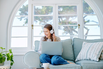 Poster - The perfect leave day. Full length shot of an attractive young woman listening to music while relaxing on the sofa at home.