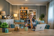 © Miljan Živković - Senior woman caucasian female hold credit card online shopping at home