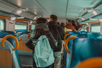 Wall Mural - Back view of crowded caucasian people queue for to exit from public train during rush hour. High quality photo