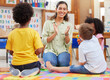 © Nina L/peopleimages.com - Sing and be happy. Shot of a teacher singing with her preschool children.