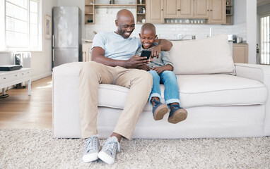 Wall Mural - We as parents are their most important role models. Shot of a father and son using a cellphone on the sofa at home.